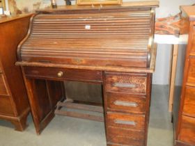 An early 20th century single pedestal roll top desk in fair condition, COLLECT ONLY.