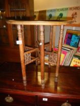 A folding table with brass top. COLLECT ONLY.