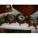 Four ships wheel barometers.