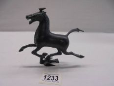 A cast metal rearing horse figure,