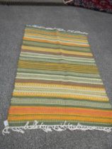 A good green patterned rug, 39 x 66 inches. COLLECT ONLY.