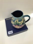A boxed Moorcroft Jug, Peony. By Phillip Gibson