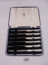 A cased set of six silver handled knives.