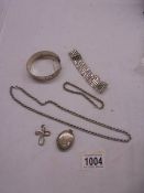 A silver bangle, silver neck chain, silver bracelet, silver locket and silver cross etc., 99 grams.