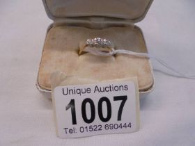 A circa 1940s three stone diamond ring stamped 18ct, size L, 2 grams.
