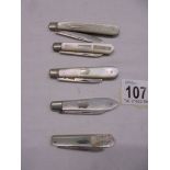 Five silver and mother of pearl fruit knives.