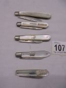Five silver and mother of pearl fruit knives.