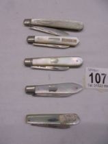 Five silver and mother of pearl fruit knives.