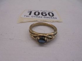 A diamond and sapphire three stone ring set in 9ct gold, size L half, 2.5 grams.