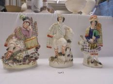 Three 19thC 'Scottish' Staffordshire figures of Highlander figures with cannon, dog and bagpipes.