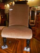 An Edwardian nursing chair in castors, COLLECT ONLY.