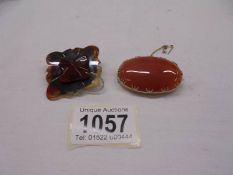 A 9ct gold set cornelian hardstone brooch with safety chain and a carved 19th century agate brooch.