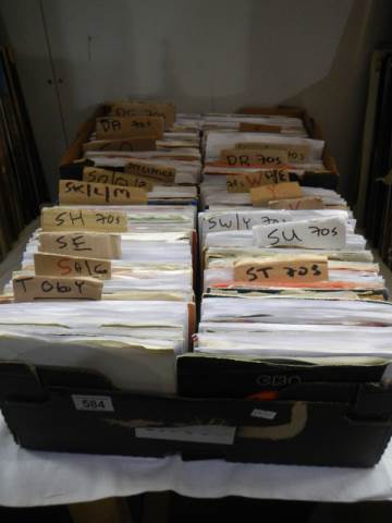 Two boxes of 45 rpm records.