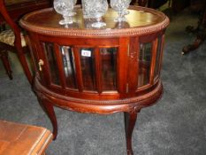 An oval mahogany drinks cabinet with bevelled glass panels, COLLECT ONLY.