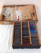 Aprroximately 180 world coins & a box of bagged bus tokens