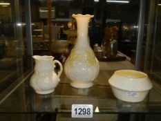 A Belleek vase, sugar bowl and cream jug.