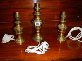 Three brass table lamp bases.