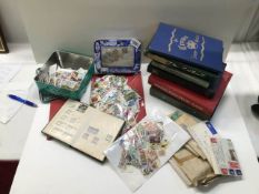 A box of assorted stamps in albums, loose and in envelopes.