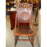 A late Victorian oak rocking chair with poker work seat and back, COLLECT ONLY.