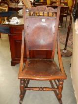 A late Victorian oak rocking chair with poker work seat and back, COLLECT ONLY.
