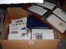 A box of stamps and stamp catalogues including albums of first day covers.