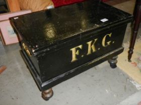 A painted pine tool box on wheels marked 'FKG' with brass handles 44 55 x 35 cm. COLLECT ONLY.
