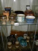 Two shelves of Studio pottery items.