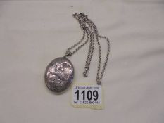 A vintage hall marked silver locket on chain.