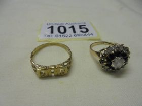 A 9ct gold 'Dad' ring size P and a 9ct gold stone set ring (missing two stones) size L, 4.6 grams.