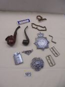 Two old pipes, metal police badges etc.,