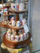 A set of porcelain thimbles on a stand (missing one thimble).