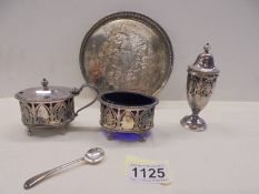A silver plate three piece condiment set on tray (mustard pot lid needs repair).