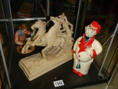 A horse with chariot figure, another figure and a figural decanter.