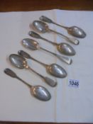 Seven silver dessert spoons.