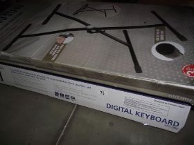 A Yamaha keyboard and a keyboard stand, new in boxes COLLECT ONLY