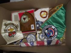 A quantity of military shield plaques, flags and badges