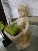An old garden statue of a girl holding a trough of plants. COLLECT ONLY.