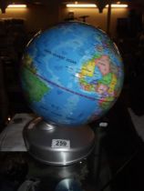 An illuminated globe night light, earth by day and night