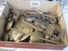 A mixed lot of clock parts including pendulums and keys