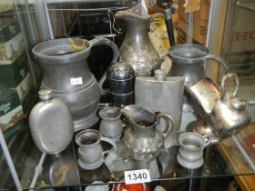 A mixed lot of pewter tankards etc.,