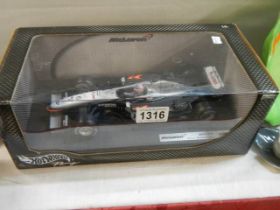 A boxed McLaren F1 car.