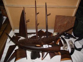A hardwood carved model of a ship, wooden whale figure and horn bird figure, all a/f