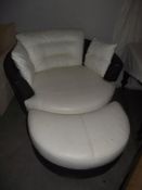 A large black and white leather rotating armchair and footstool COLLECT ONLY