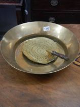 A brass pan and a brass milk skimmer.