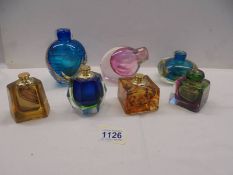 Seven items of Studio glass including inkwells and scent bottles.