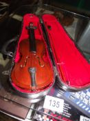 A miniature violin in case
