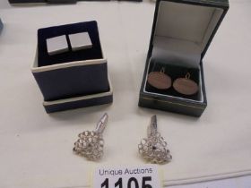 Two pairs of silver cuff links and a pair of rollled gold cuff links.