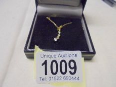 A diamond pendant set brilliants and two yellow diamonds on 9ct gold chain, 1.6 grams.