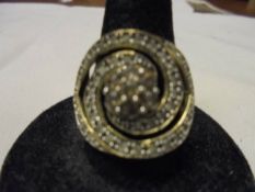 A 9ct yellow gold large swirl diamond set ring, size N, 3.1 grams.
