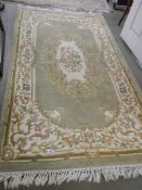 A green patterned rug, 200 x 122 cm, in good condition, COLLECT ONLY.